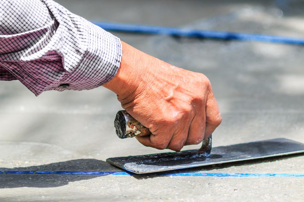 Slab leak Image of a slab leak, featuring Knee Deep Plumbing and highlighting expert slab leak detection services to prevent water damage and structural issues.